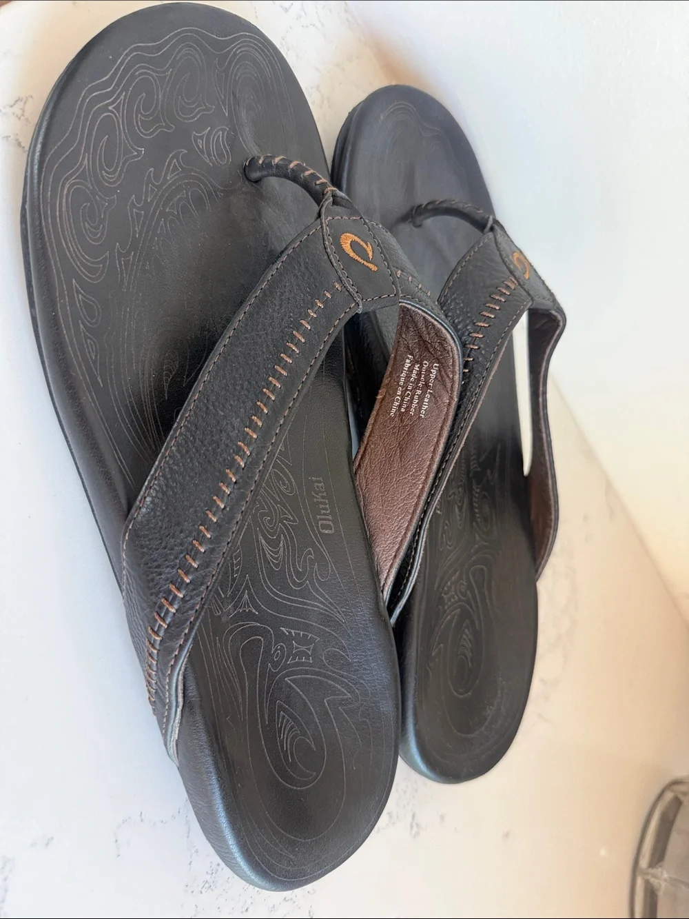 OluKai Men's Hiapo Leather flip-flops Sandals Black Whipstitching Moko Tattoo